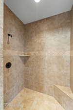 Full bathroom featuring tiled shower