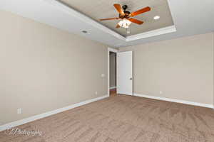 Carpeted empty room featuring a tray ceiling, wooden ceiling, recessed lighting, and ceiling fan