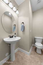 Bathroom featuring baseboards and light tile patterned floors