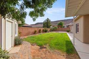 Fenced backyard featuring a mountain view