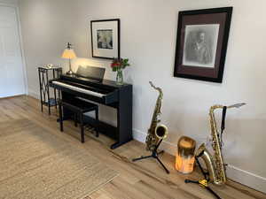 Living area with light wood-style flooring and baseboards