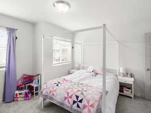 Bedroom featuring carpet floors and baseboards