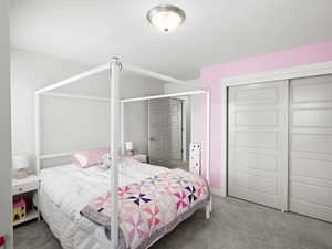 Bedroom with carpet and a closet