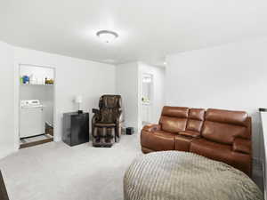 Carpeted living area featuring washer / clothes dryer and baseboards