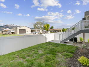 View of yard with a mountain view, stairway, a residential view, and a garage