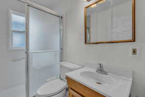 Bathroom featuring vanity and a stall shower