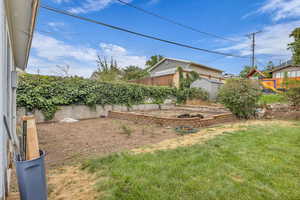 Fenced backyard featuring a playground and a shed