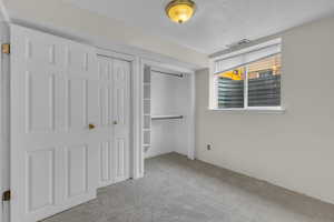 Unfurnished bedroom with a closet and carpet floors