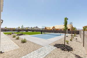 View of sport court with a residential view and a tennis court
