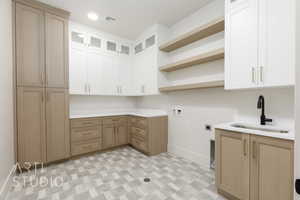 Laundry room featuring cabinet space, washer hookup, hookup for an electric dryer, light flooring, and recessed lighting