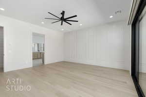 Unfurnished bedroom featuring light wood-style floors, a ceiling fan, recessed lighting, and ensuite bathroom