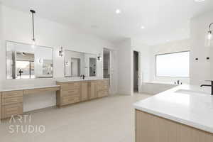 Bathroom featuring two vanities, light tile patterned floors, recessed lighting, a bath, and a closet