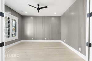 Empty room with light wood-style flooring, ceiling fan, and recessed lighting