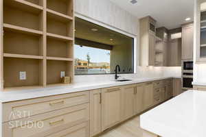 Kitchen with light brown cabinetry, tasteful backsplash, open shelves, stainless steel appliances, and recessed lighting