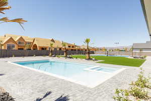 View of pool featuring a patio, a residential view, and a pool with connected hot tub