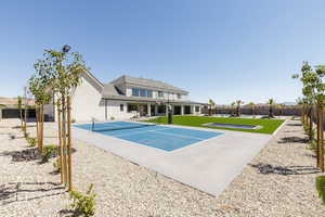 View of basketball court with a patio area, a fenced backyard, and community basketball court