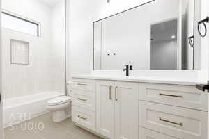 Bathroom featuring vanity, light tile patterned floors, and bathtub / shower combination