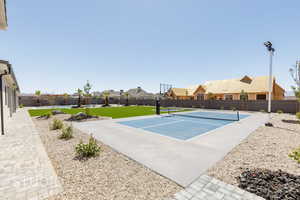View of tennis court featuring a residential view