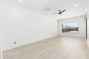 Spare room with light wood-style flooring, a ceiling fan, and recessed lighting