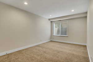 Spare room featuring light carpet and recessed lighting