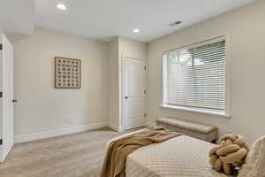 Bedroom with recessed lighting and light carpet