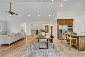 Dining room featuring arched walkways, recessed lighting, lofted ceiling, and ceiling fan