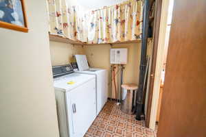 Laundry area with tile patterned flooring and washer and dryer
