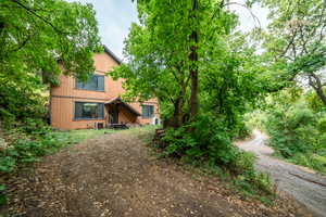 View of front of house featuring a wooden deck