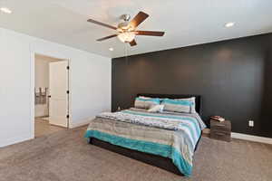 Bedroom featuring recessed lighting, a ceiling fan, carpet, and connected bathroom