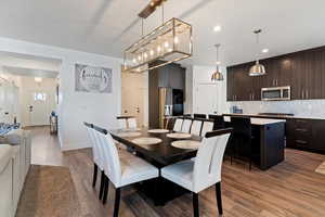 Dining area with dark wood finished floors and recessed lighting