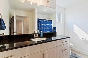 Bathroom featuring vanity, a shower with shower curtain, and light tile patterned floors