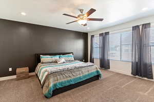 Bedroom with carpet flooring, a ceiling fan, and recessed lighting