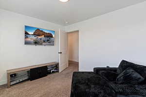 Living area with carpet and baseboards