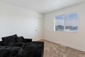 Sitting room with light carpet and baseboards