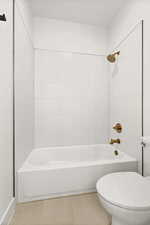 Full bathroom featuring shower / bath combination and tile patterned floors