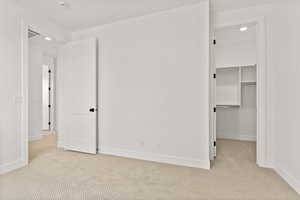 Unfurnished bedroom with recessed lighting, carpet, and a walk in closet
