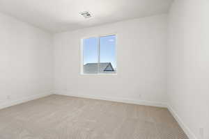 Carpeted empty room with baseboards