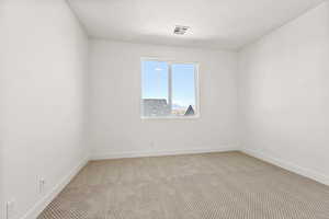 Unfurnished room featuring carpet floors and baseboards
