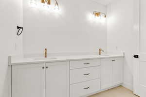 Bathroom featuring double vanity and light tile patterned flooring