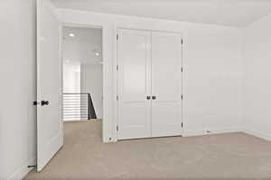 Unfurnished bedroom featuring carpet flooring, recessed lighting, and a closet