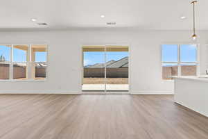Unfurnished living room featuring light wood-type flooring and recessed lighting