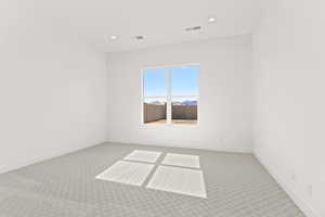 Carpeted spare room featuring recessed lighting