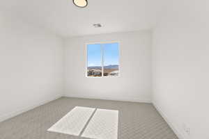 Carpeted empty room featuring baseboards and a mountain view