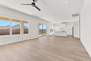 Unfurnished living room with light wood-style flooring, recessed lighting, and ceiling fan