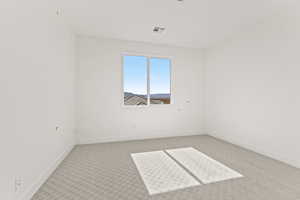 Carpeted spare room featuring baseboards