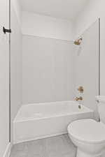 Bathroom featuring  shower combination and tile patterned flooring