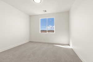 Empty room featuring carpet floors and baseboards