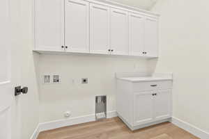 Washroom featuring light wood-type flooring, hookup for a washing machine, hookup for a gas dryer, cabinet space, and hookup for an electric dryer