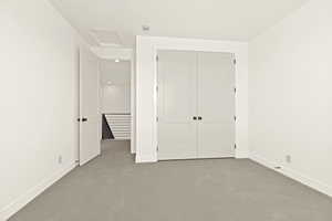 Unfurnished bedroom featuring carpet floors and a closet