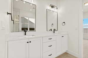 Full bath with double vanity, light tile patterned flooring, and recessed lighting